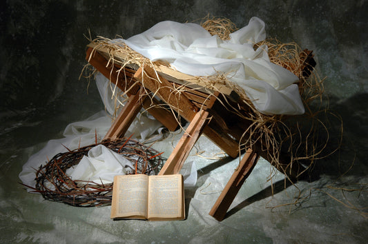 "Baby Jesus resting in a straw-filled basinet, symbolizing His humble birth in Bethlehem."